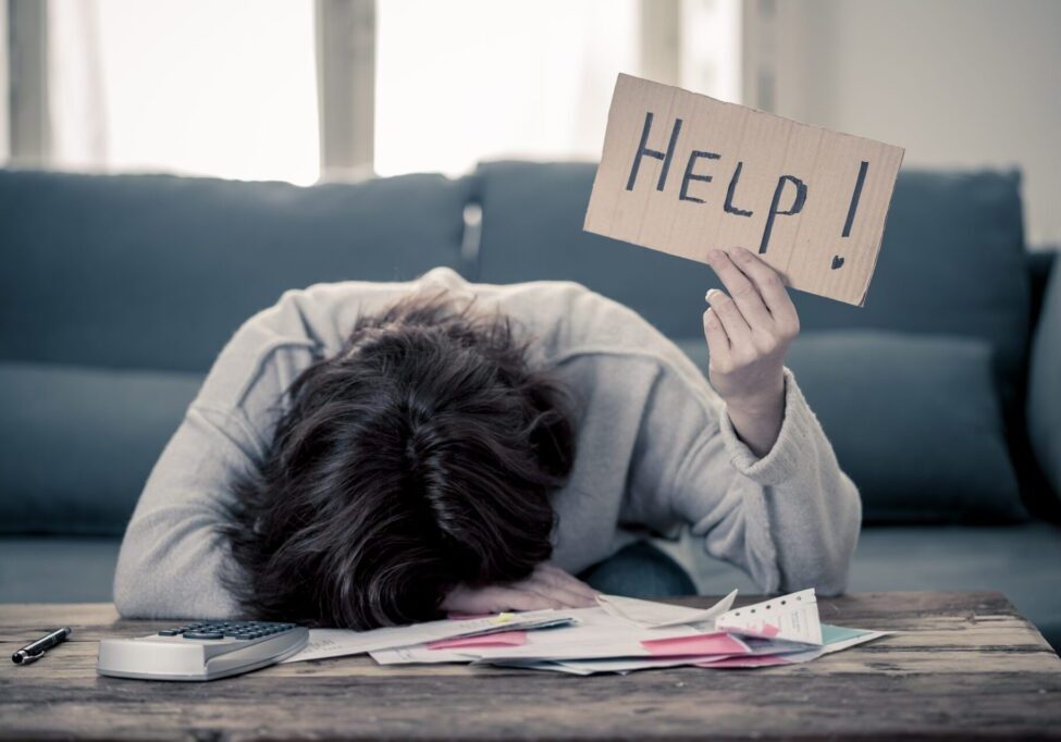 Upset young woman asking for help in paying bills Mortgage home or business finance problems Worried and desperate woman asking for help in paying off debts and loan calculating bills tax expenses and accounting home finances sitting on couch in Domestic bills and Financial problems concept.